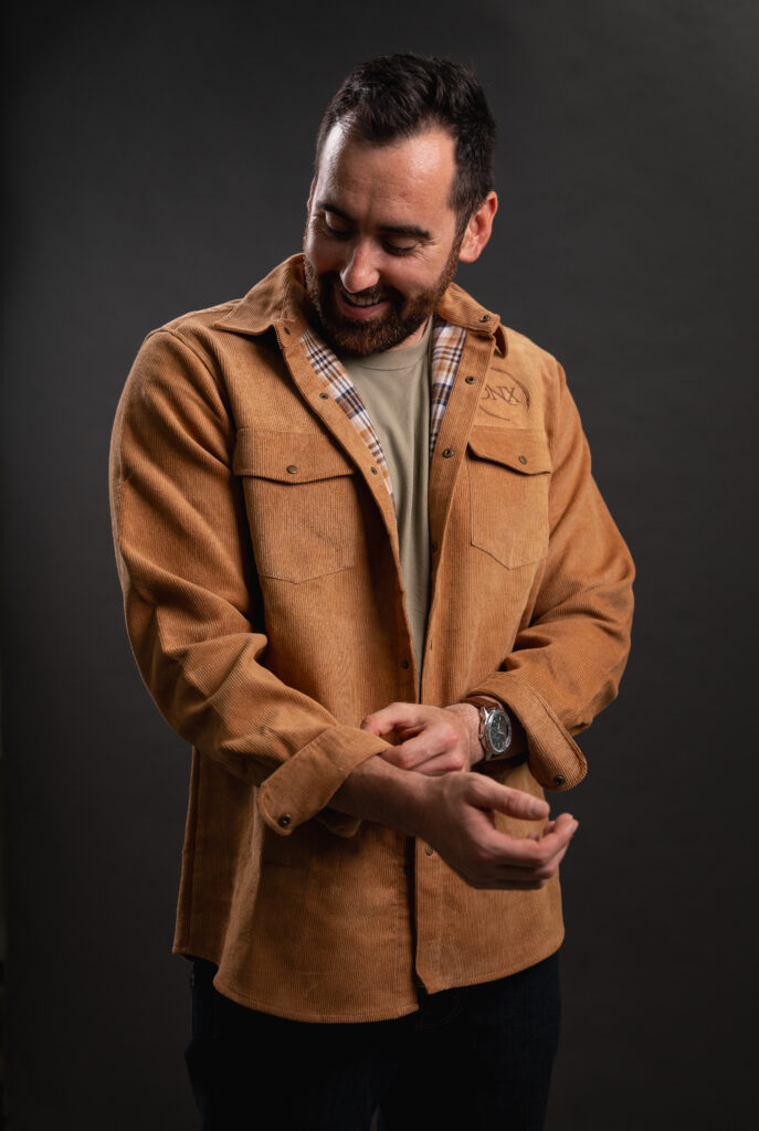 Image of http://Bearded%20man%20wearing%20tan%20corduroy%20shacket%20with%20ONX%20logo%20and%20fixing%20his%20sleeve