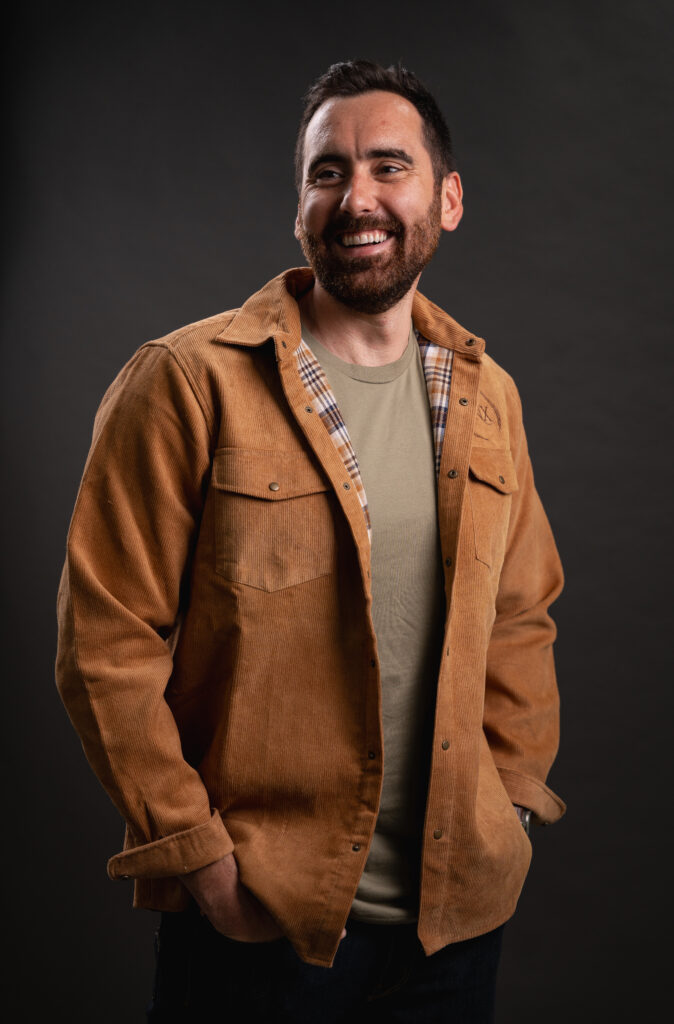 Image of http://Bearded%20man%20looking%20out%20in%20the%20distance%20wearing%20a%20tan%20corduroy%20shacket%20with%20the%20ONX%20logo